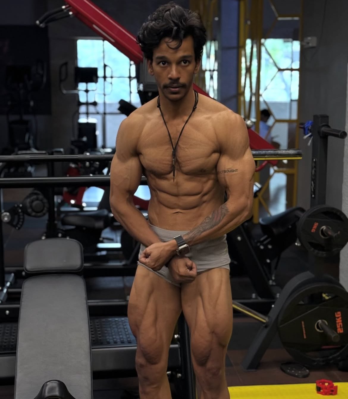 Loki gym posing showing shredded physique